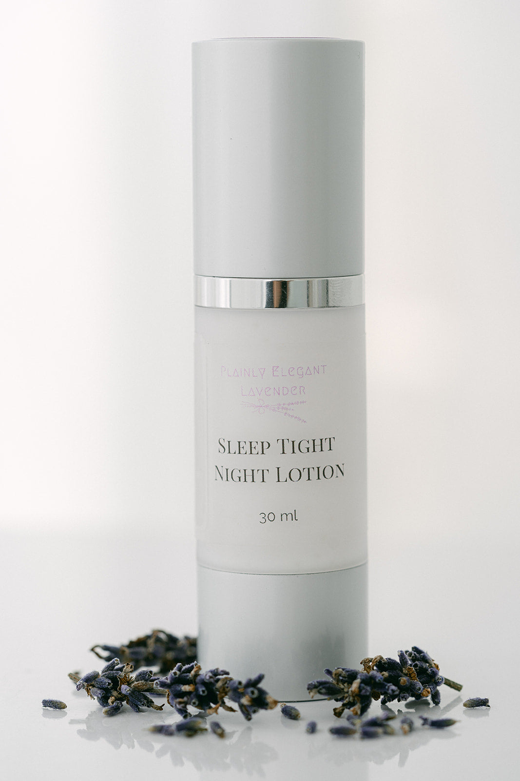 Skincare bottle labeled 'Sleep Tight Night Lotion' on a white background with dried herbs.