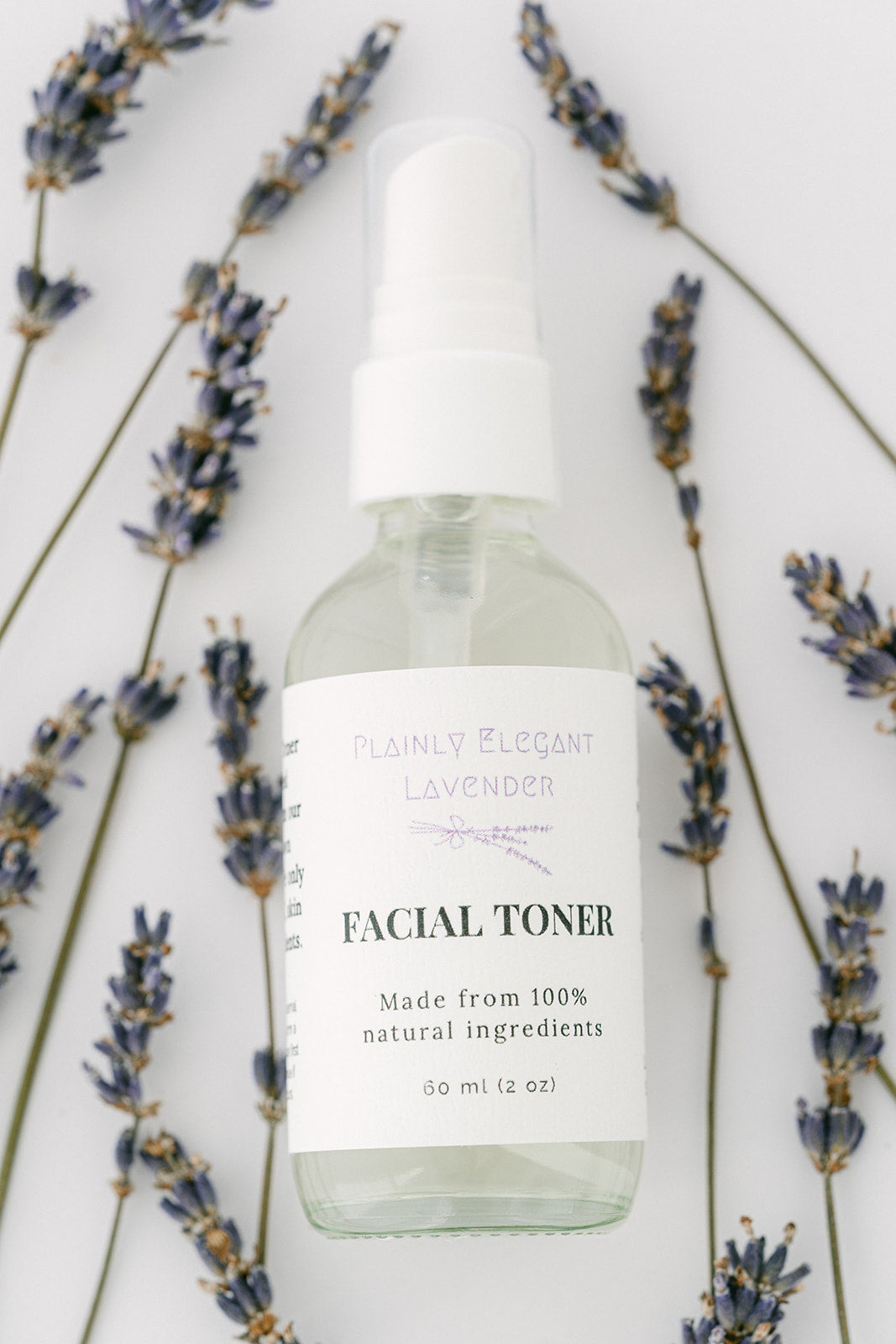 Lavender Facial toner bottle with lavender flowers on a white background
