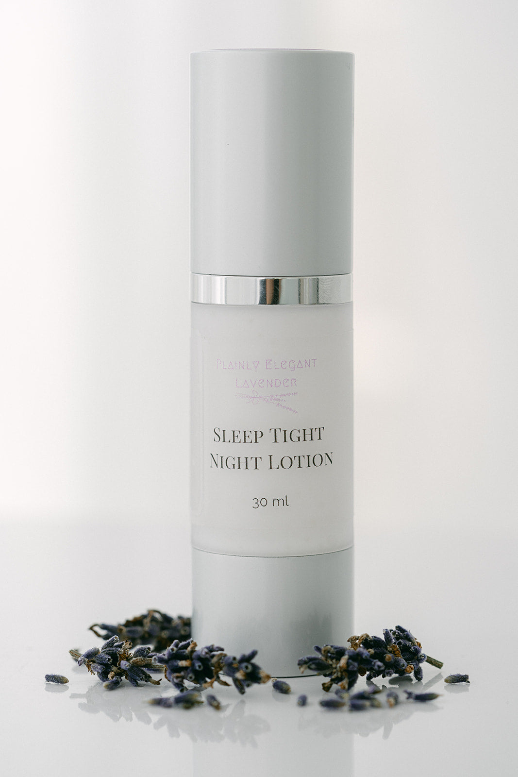 Skincare bottle labeled 'Sleep Tight Night Lotion' with dried lavender flowers on a white background